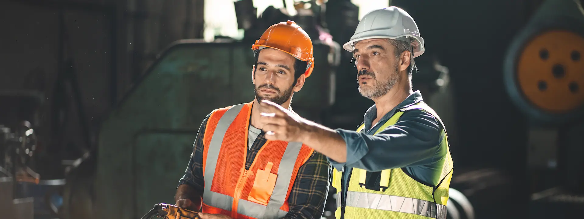 Senior and junior colleagues on a factory floor